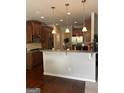 Open kitchen with wooden cabinets, granite countertops, and pendant lighting over the bar at 8109 Nolan Trl, Snellville, GA 30039