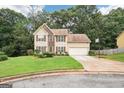 Charming two-story home with neutral siding, brown shutters, lush lawn and driveway at 2580 Star Ln, Decatur, GA 30034