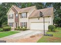 Two-story home with a two car garage, basketball hoop and manicured lawn at 2580 Star Ln, Decatur, GA 30034