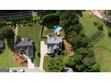Aerial view of a home and lot with an above-ground pool in the fenced backyard and mature trees at 53 Denny Ln, Dallas, GA 30157