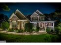 Nighttime view of a beautiful home with stone and siding, enhanced by landscape lighting and a starry sky at 53 Denny Ln, Dallas, GA 30157