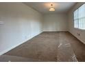Spacious living room featuring neutral carpeting and a large window providing plenty of natural light at 110 Riley Ave, Fayetteville, GA 30214