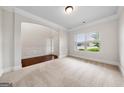 Bright living room with white trim and walls, large window, light carpet and hardwood floors at 3865 Rifflepool Ct, Douglasville, GA 30135