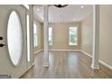 Light-filled foyer showcases wood-look floors, decorative columns, and modern lighting at 1709 Reese Rd, Sharpsburg, GA 30277