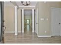 Bright foyer with modern wood-look floors, decorative columns, and neutral paint tones at 1709 Reese Rd, Sharpsburg, GA 30277