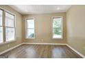 Inviting living room features ample natural light and modern wood-look flooring at 1709 Reese Rd, Sharpsburg, GA 30277