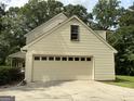 Attached two-car garage with a multi-paneled door and concrete driveway at 807 Oak Bridge Ln, Fayetteville, GA 30214