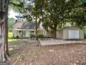 A beautiful single Gathering home with a spacious front yard, mature trees and a detached garage at 6192 Collins Ne St, Covington, GA 30014
