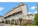 Townhouse exterior showcasing brick accents, balconies, and manicured landscaping at 1100 Thomas St, Woodstock, GA 30188