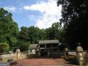 Beautiful home with brick courtyard, retaining wall with pillar accents, and lush surrounding landscape at 5523 Bahia Mar Cir, Stone Mountain, GA 30087