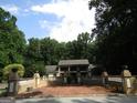 Beautiful home with brick courtyard, retaining wall with pillar accents, and lush surrounding landscape at 5523 Bahia Mar Cir, Stone Mountain, GA 30087