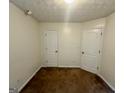 Cozy bedroom with neutral walls, carpeted floors, and two doors, perfect for relaxation at 6367 Ellenwood Drive, Rex, GA 30273