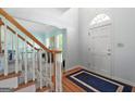 Inviting foyer with hardwood floors, staircase, and a view into the living area, creating a warm welcome at 150 Tramore Trce, Tyrone, GA 30290