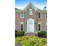 Close-up of the home's front entrance, showcasing its brick facade and white front door at 150 Tramore Trce, Tyrone, GA 30290