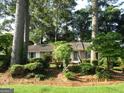 A cozy single-story home nestled among mature trees and lush landscaping, offering a private setting at 3048 Haverford Se Ln, Marietta, GA 30067