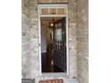 Inviting entryway featuring a modern front door with glass panels, offering a glimpse into the home's interior and dark hardwood floors at 2920 Prestwood Dr, Cumming, GA 30040