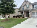 Well-maintained home showcasing lush landscaping, a driveway, and a mix of brick and siding on the facade at 2920 Prestwood Dr, Cumming, GA 30040
