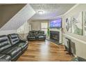 Inviting living room with a fireplace, hardwood floors, and comfortable seating at 447 Sherwood Cir, Stone Mountain, GA 30087