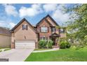 Beautiful two-story home featuring a brick and siding exterior, a well-kept lawn and mature landscaping at 2619 Dayview, Atlanta, GA 30331