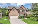 Attractive two-story home with a brick and siding design, manicured bushes, and a spacious driveway at 2619 Dayview, Atlanta, GA 30331