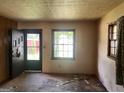Empty living room showing wood floors and windows at 6337 Wellington Way, Austell, GA 30106