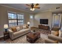 Bright living room showcases a large window, plush sofa and stylish decor at 11 Grove Ln, Hampton, GA 30228