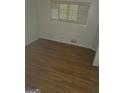 Inviting bedroom showcasing hardwood floors, a window, and neutral wall paint at 2527 Amalfi Dr, Conyers, GA 30012
