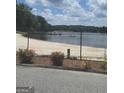 Beautiful lake view highlighting the serene waterfront property and mature trees at 2527 Amalfi Dr, Conyers, GA 30012