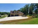 Spacious three car garage and large driveway perfect for parking multiple vehicles at 90 Alcovy Reserve Way, Covington, GA 30014