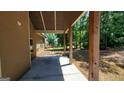 Covered patio with wooden support beams ideal for entertaining or relaxing outdoors at 90 Alcovy Reserve Way, Covington, GA 30014