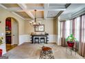 Dining room with a coffered ceiling, elegant chandelier, and a bar for entertaining at 697 Chapman, Jonesboro, GA 30238