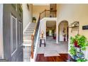 Inviting foyer with hardwood floors, staircase and an open view into the main living area. Plants add a nice touch at 697 Chapman, Jonesboro, GA 30238