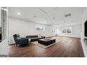 Bright, spacious living room with hardwood floors, large windows, and modern furniture at 1 Lamar Ave Sw, Atlanta, GA 30310