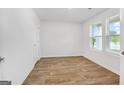 Bright, spacious bedroom with wood-look flooring and a double window, ready for customization and relaxation at 1184 Bluecoat Cir # 84, Hampton, GA 30228