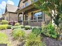 Inviting front porch with decorative railings, lush plantings, and a cozy atmosphere at 206 Birchin Dr, Woodstock, GA 30188