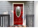 Inviting red front door with decorative glass and white trim offers a warm welcome to the home at 1675 Brewer Sw Blvd, Atlanta, GA 30310