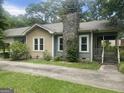 Charming two-story home with stone chimney, offering a cozy and inviting appeal at 212 Rockmart Rd, Villa Rica, GA 30180
