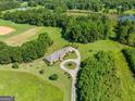 Expansive property featuring a well-manicured lawn, lush trees and winding driveway at 226 Euharlee Five Forks Rd, Kingston, GA 30145