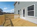 New home features a wooden deck and a door that leads into the interior of the house at 257 Orwell Drive Lot 48 # 48, Social Circle, GA 30025