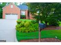 Lovely brick exterior, with manicured landscaping and attached garage, exudes curb appeal at 122 Carolinas Way, Fayetteville, GA 30215