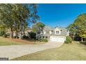 Two story home with a well manicured yard with a two car garage and long driveway in a suburban setting at 214 Palette Ln, Peachtree City, GA 30269