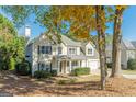Two story home with a well manicured yard with mature trees and landscaping in a suburban setting at 214 Palette Ln, Peachtree City, GA 30269
