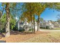 Two story home with a well manicured yard with mature trees and landscaping in a suburban setting at 214 Palette Ln, Peachtree City, GA 30269
