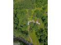 Aerial view showcases a secluded property surrounded by lush greenery and mature trees at 183 Inman Rd, Fayetteville, GA 30215