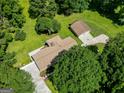 Aerial view displays home's roof, detached garage, and mature trees at 183 Inman Rd, Fayetteville, GA 30215