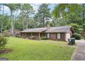 Inviting ranch-style home with a cozy front porch, lush lawn, and convenient driveway access at 5618 Shadow Rock Dr, Lithonia, GA 30058