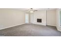 Cozy living room features a fireplace, new carpet, and plenty of natural light at 5618 Shadow Rock Dr, Lithonia, GA 30058