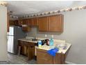 Kitchen with stainless steel refrigerator, wooden cabinets, and some counter space at 5908 Trent Jones Way, Lithonia, GA 30038