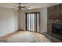 Living room with a stone fireplace, sliding glass doors and significant damage on floor at 5908 Trent Jones Way, Lithonia, GA 30038