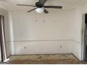 Empty living room featuring a ceiling fan and walls with some damage at 5908 Trent Jones Way, Lithonia, GA 30038